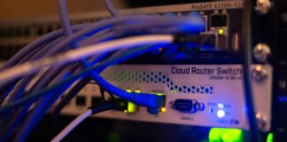 वेबसाइट सुरक्षित राख्न के गर्ने? PHP र WordPress प्रयोगकर्ताका लागि सात सावधानी Network cables connected to computer networking equipment, illustrating digital infrastructure and cybersecurity