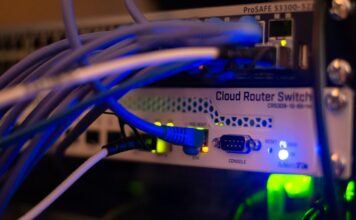Network cables connected to computer networking equipment, illustrating digital infrastructure and cybersecurity