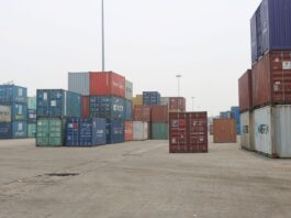 निर्यात ६१.९ प्रतिशत बढ्दा पनि व्यापार घाटा किन फराकिलो भयो? Stacks of shipping containers at Birgunj Dry Port, Nepal, illustrating the country's merchandise trade and logistics network.