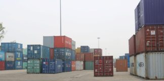 निर्यात ६१.९ प्रतिशत बढ्दा पनि व्यापार घाटा किन फराकिलो भयो? Stacks of shipping containers at Birgunj Dry Port, Nepal, illustrating the country's merchandise trade and logistics network.