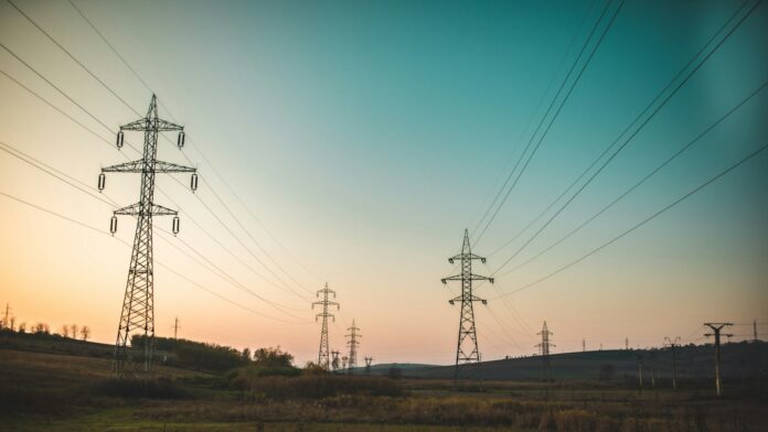 High-voltage electricity transmission towers and power lines, representative image for the Kaligandaki Corridor transmission line restoration story