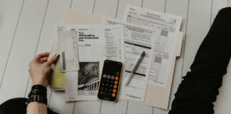 Budget papers, calculator and financial documents on a desk, representing public spending analysis